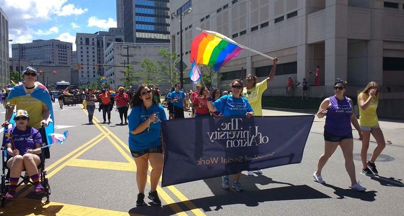 Students participate in the PRIDE parade in downtown Akron